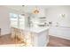 Modern white kitchen with large island and stainless steel appliances at 4730 Down Setting Rd, Cumming, GA 30028