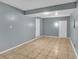 Gray-walled basement with tile floor, offering ample space and two doors at 2729 Oxford Dr, Decatur, GA 30034