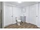 Basement bathroom with toilet and vanity; grey cabinet at 2729 Oxford Dr, Decatur, GA 30034