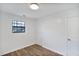 Simple bedroom with light wood laminate flooring and window at 2729 Oxford Dr, Decatur, GA 30034