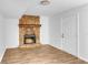 Living room featuring a stone fireplace, wood-look flooring, and a white door at 2729 Oxford Dr, Decatur, GA 30034