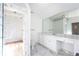 Elegant bathroom with marble shower, double vanity, and large mirror at 2933 Andrews Nw Dr, Atlanta, GA 30305