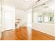 Bright hallway with hardwood floors, mirrored wall, and staircase at 2933 Andrews Nw Dr, Atlanta, GA 30305