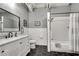 This bathroom offers a classic design with subway tiles, a marble-top vanity, and black hexagon tile flooring at 878 Peachtree Ne St # 535, Atlanta, GA 30309