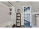 Bright bathroom showcasing a tub with a shower curtain, black hexagonal tile flooring, and exposed duct work at 878 Peachtree Ne St # 535, Atlanta, GA 30309