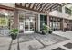 Modern building entrance with glass doors and potted plants at 878 Peachtree Ne St # 535, Atlanta, GA 30309