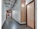 Clean and well-lit hallway with exposed pipes and modern wall decor at 878 Peachtree Ne St # 535, Atlanta, GA 30309