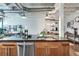 Kitchen island featuring stainless steel dishwasher and undermount sink with dark granite countertops at 878 Peachtree Ne St # 535, Atlanta, GA 30309