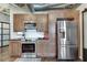 Kitchen featuring stainless steel appliances and wood cabinets in an industrial condo with ductwork exposed at 878 Peachtree Ne St # 535, Atlanta, GA 30309