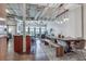 Open living space in modern industrial condo with dining, kitchen, and living area with ductwork exposed at 878 Peachtree Ne St # 535, Atlanta, GA 30309