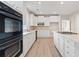 Modern kitchen with double ovens and white cabinetry at 5026 Duxford Se Dr, Smyrna, GA 30082