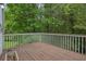 Corner view of a wood back deck overlooking lush greenery at 4127 Conley Pond Ct, Decatur, GA 30034