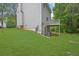 Backyard showcasing the exterior of a home and lush green lawn at 4127 Conley Pond Ct, Decatur, GA 30034