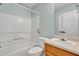 Bathroom featuring a shower-tub combo, toilet, and vanity with sink and oak cabinets at 4127 Conley Pond Ct, Decatur, GA 30034