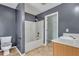 Standard bathroom featuring a shower-tub combo, toilet, and vanity with a white countertop and neutral flooring at 4127 Conley Pond Ct, Decatur, GA 30034