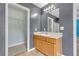 Bathroom with a wooden vanity, single sink, and a mirror, with a view of the shower and closet at 4127 Conley Pond Ct, Decatur, GA 30034