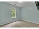 Bedroom with a window, neutral carpeting, and light blue walls at 4127 Conley Pond Ct, Decatur, GA 30034