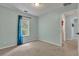 Bedroom with neutral walls, patterned carpeting, and a window with blue curtains at 4127 Conley Pond Ct, Decatur, GA 30034