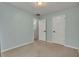 Bedroom with neutral walls, carpet flooring, two white doors and trim, plus overhead lighting at 4127 Conley Pond Ct, Decatur, GA 30034