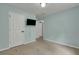 Bedroom featuring blue walls, patterned carpeting, and a wall-mounted television at 4127 Conley Pond Ct, Decatur, GA 30034