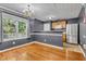Dining area with hardwood floors, chandelier, and stainless steel refrigerator with a view into the kitchen at 4127 Conley Pond Ct, Decatur, GA 30034