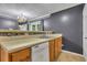 Traditional kitchen featuring stone backsplash, tiled floors, and a stainless steel sink at 4127 Conley Pond Ct, Decatur, GA 30034