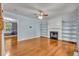 Open-concept living room with hardwood floors, fireplace with built-in shelves and lots of natural light at 4127 Conley Pond Ct, Decatur, GA 30034