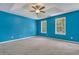Spacious main bedroom with plush carpet and multiple windows at 4127 Conley Pond Ct, Decatur, GA 30034