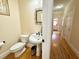 Small bathroom with pedestal sink and hardwood floors at 1411 River Station Dr, Lawrenceville, GA 30045