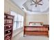 Main bedroom with wood sleigh bed and large window at 1411 River Station Dr, Lawrenceville, GA 30045