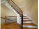 Elegant curved staircase with wood and wrought iron at 1411 River Station Dr, Lawrenceville, GA 30045