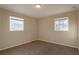 Bright bedroom with neutral walls, carpet, and two windows at 9105 Griffin Sw Ln, Covington, GA 30014