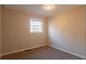 Simple bedroom with neutral walls, carpet, and one window at 9105 Griffin Sw Ln, Covington, GA 30014