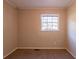 Small bedroom with neutral walls, carpet and one window at 9105 Griffin Sw Ln, Covington, GA 30014