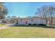 Ranch style home with brick exterior, red door, and carport at 9105 Griffin Sw Ln, Covington, GA 30014