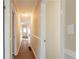 Long hallway with light walls and wood flooring at 9105 Griffin Sw Ln, Covington, GA 30014