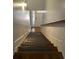 Welcoming staircase featuring wooden steps and white wainscoting, leading to a bright entrance at 655 Mead St # 28, Atlanta, GA 30312