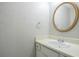 Small bathroom with a sink, vanity, and an oval mirror at 4626 Garden Hills Dr, Stone Mountain, GA 30083