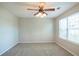 Spacious bedroom featuring a ceiling fan and large window at 4626 Garden Hills Dr, Stone Mountain, GA 30083