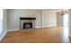 Spacious living room with hardwood floors and a brick fireplace at 4626 Garden Hills Dr, Stone Mountain, GA 30083