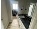 Hall bathroom with framed mirror, modern lighting, black tile accents, and white vanity at 5145 Dublin Sw Dr, Atlanta, GA 30331