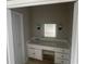 Bathroom vanity with white cabinets, framed mirror, and modern lighting fixtures at 5145 Dublin Sw Dr, Atlanta, GA 30331