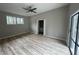 Bright bedroom features a ceiling fan, wood floors, and access to the outdoor deck at 5145 Dublin Sw Dr, Atlanta, GA 30331