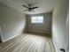 Neutral bedroom features a ceiling fan, window, and light wood laminate flooring at 5145 Dublin Sw Dr, Atlanta, GA 30331