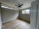 Neutral bedroom with lots of light, a ceiling fan, and wood laminate flooring at 5145 Dublin Sw Dr, Atlanta, GA 30331