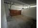 Unfinished garage with a rolling garage door and concrete flooring at 5145 Dublin Sw Dr, Atlanta, GA 30331