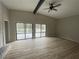 Spacious living room with vaulted ceilings, wood floors, fireplace and sliding glass doors leading to the deck at 5145 Dublin Sw Dr, Atlanta, GA 30331