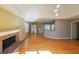 Living room with hardwood floors, fireplace, and access to kitchen at 2114 Lindley Nw Ln, Kennesaw, GA 30144