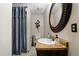 Traditional bathroom features a shower with curtain, vanity with an oval mirror, and tiled floors at 4286 Pool Rd, Winston, GA 30187