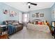 Cozy bedroom with comfortable seating, natural light, and a daybed decorated with stuffed animals at 4286 Pool Rd, Winston, GA 30187
